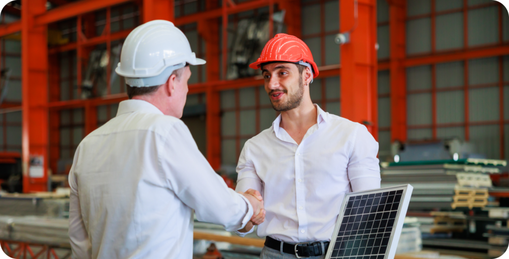 A representation of a Solar maintenance tech shaking hands with a customer. Both are wearing hard hats.